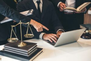 Pointing out attorney retention on a laptop