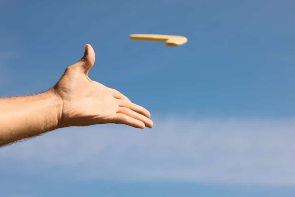 Hand throwing boomerang into sky to represent rehireable boomerang lawyers
