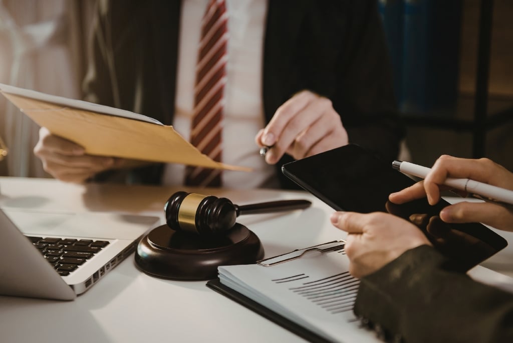 Legal recruiter reviewing documents with candidate at a desk with a gavel