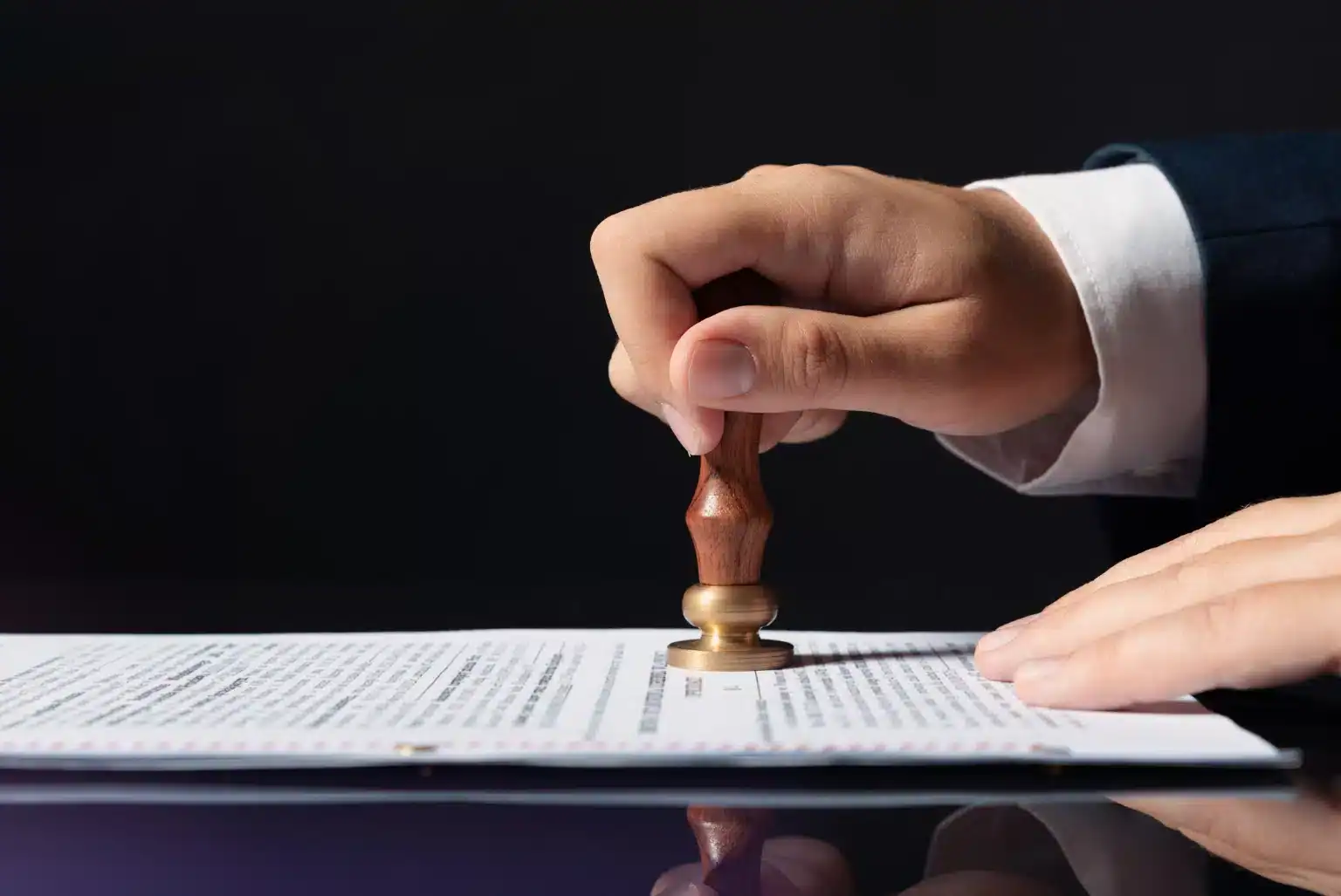 Hand stamping paper to approve changes to legal roles across practice areas